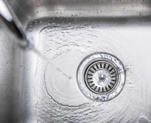 Water flowing down the hole in a kitchen sink